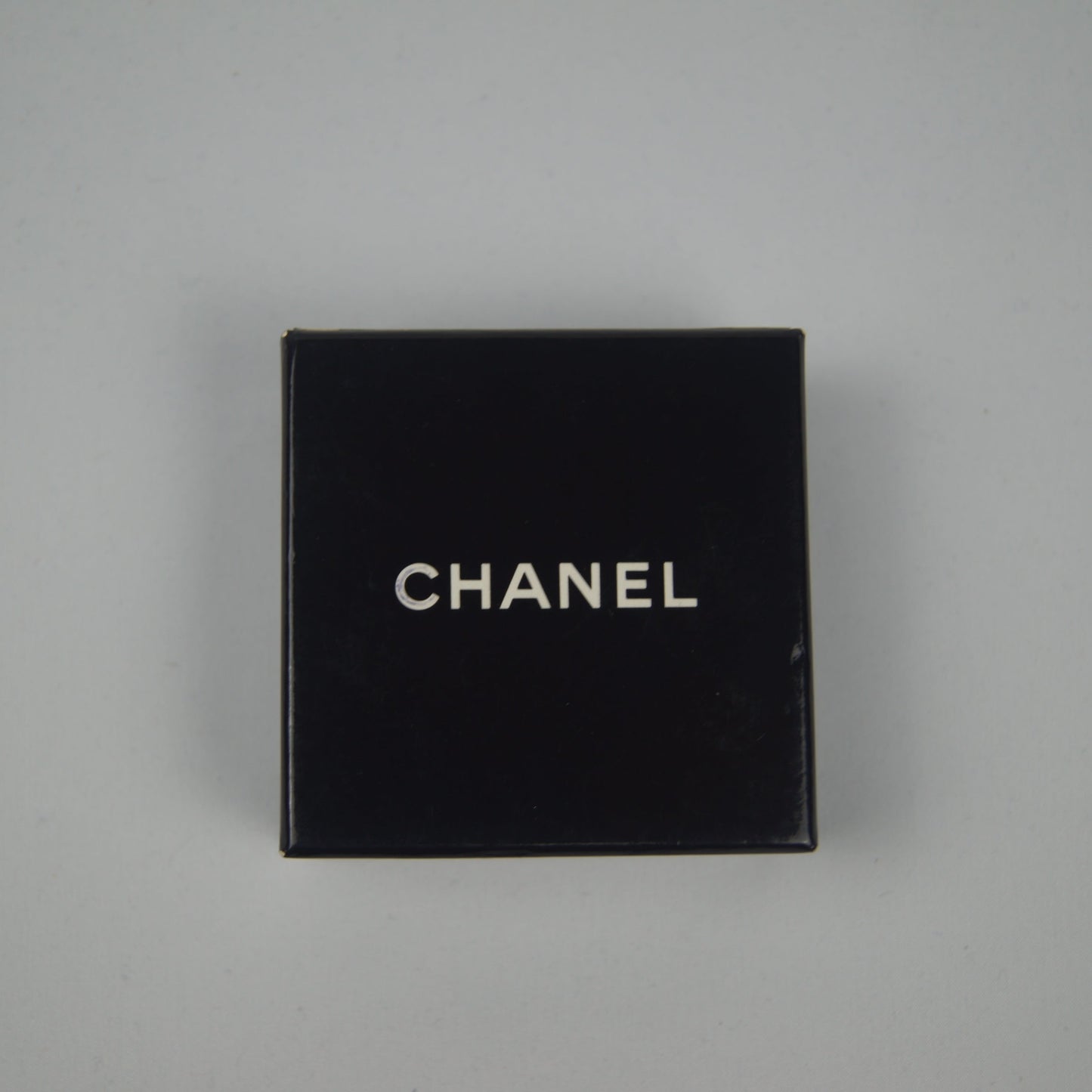 Black Chanel box on a gray background