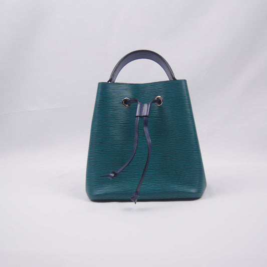 Green handbag with a bluehandle on a white background