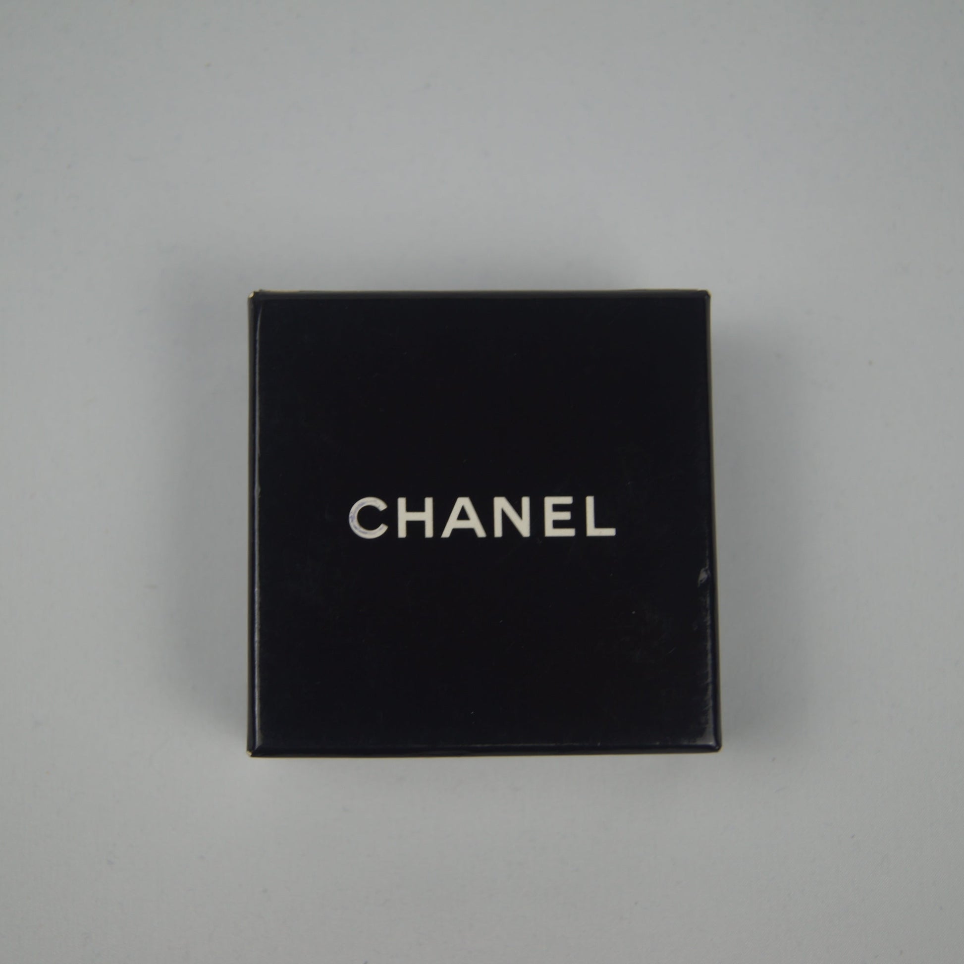Black Chanel box on a gray background